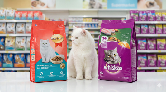 A high-quality product comparison photograph featuring two bags of dry cat food standing side-by-side on a glossy white surface. On the left is a bag with vibrant Red packaging representing SmartHeart